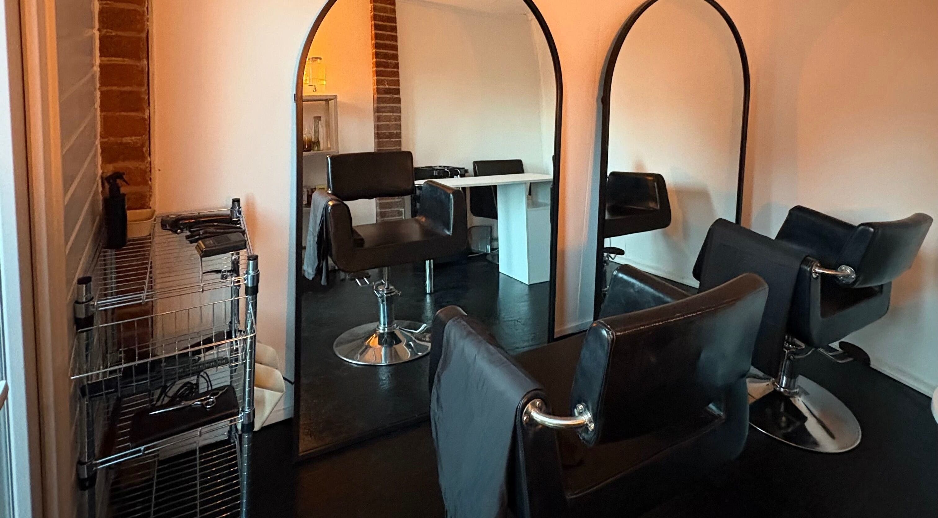 Elegant salon setup at Concept.6, Rainworth, England with modern chairs and mirrors.