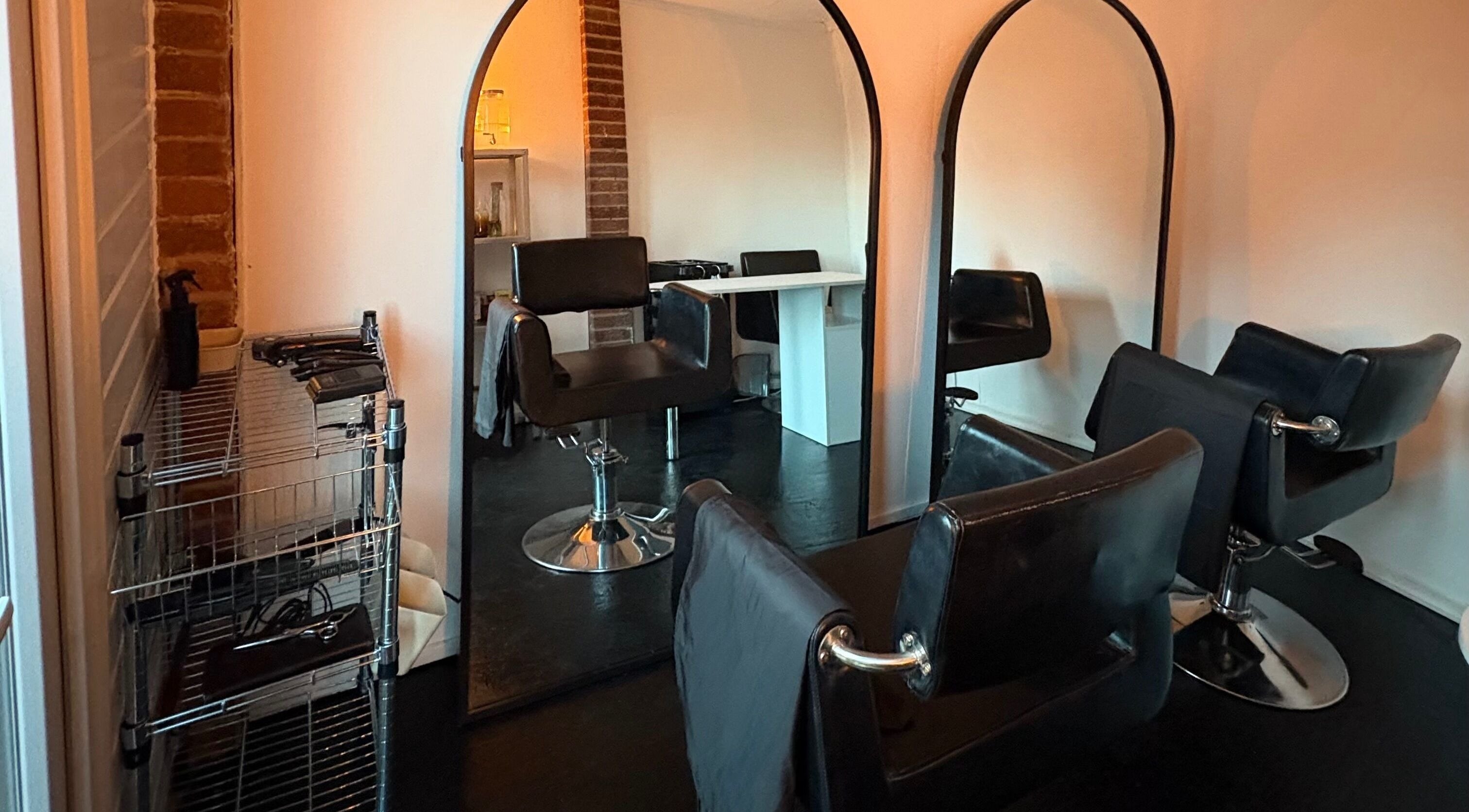 Elegant salon setup at Concept.6, Rainworth, England with modern chairs and mirrors.