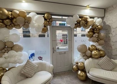 Luxurious seating with gold and white balloons at Luxe Haven Cosmetics, Bradford, England, GB.