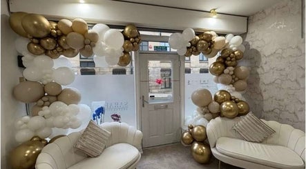 Luxurious seating with gold and white balloons at Luxe Haven Cosmetics, Bradford, England, GB.