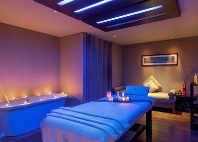 Elegant spa room with candles and tub at Zayna Spa, Abu Dhabi, Abu Dhabi, AE, offering a serene atmosphere.