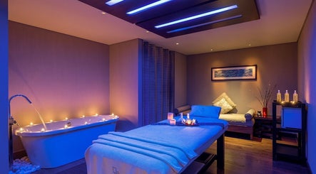 Elegant spa room with candles and tub at Zayna Spa, Abu Dhabi, Abu Dhabi, AE, offering a serene atmosphere.