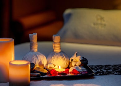 Relaxing spa setup with candles and herbal compress at Zayna Spa, Abu Dhabi, Abu Dhabi, AE.