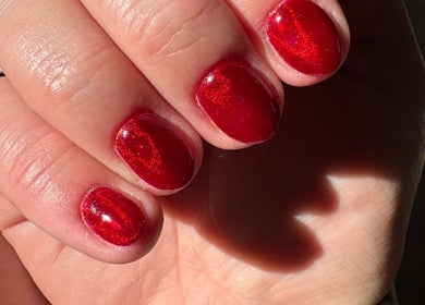 Close-up of vibrant red manicure from Nails by Becs in Desborough, England, GB showcasing glossy nail polish.