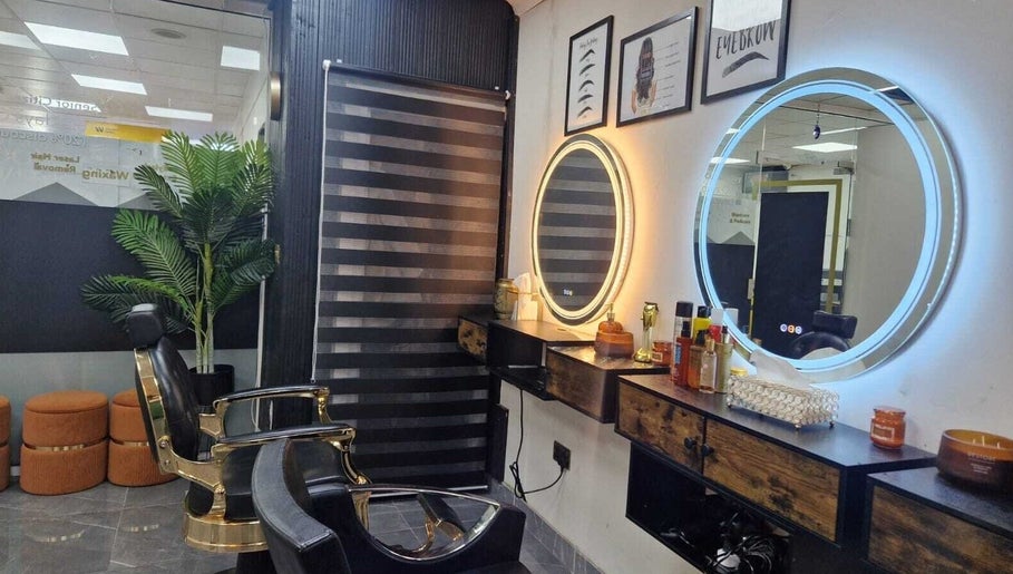 Modern beauty salon interior at Ray's House of Beauty, Hounslow, England, GB, showcasing stylish mirrors and chairs.