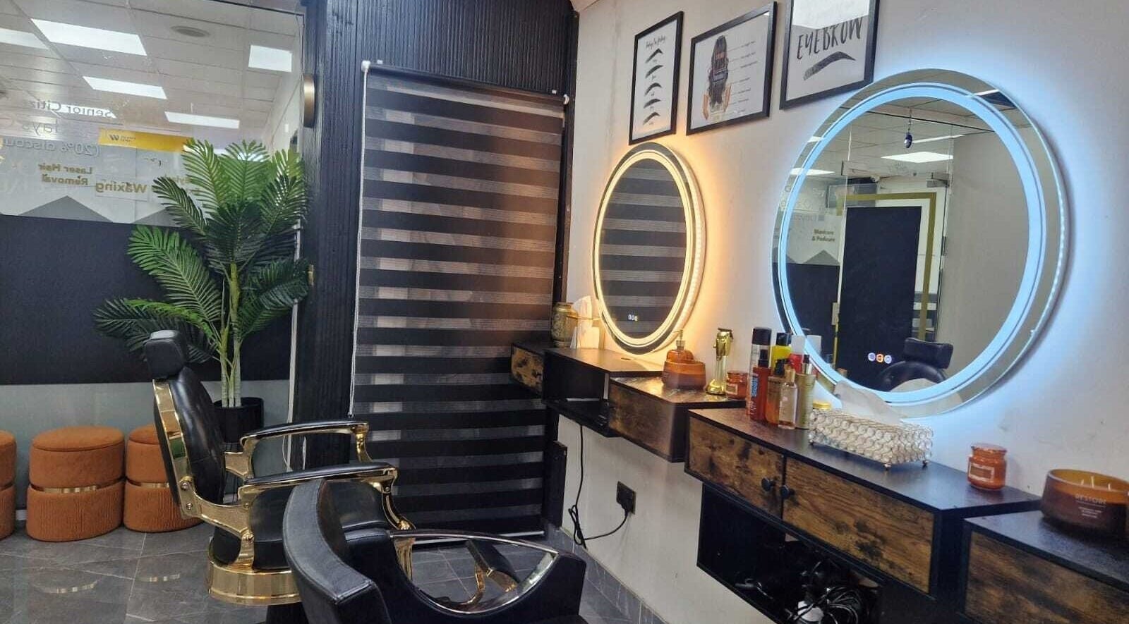 Modern beauty salon interior at Ray's House of Beauty, Hounslow, England, GB, showcasing stylish mirrors and chairs.