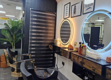 Modern styling chair and illuminated mirrors at Ray's House of Beauty, Hounslow, England, GB.