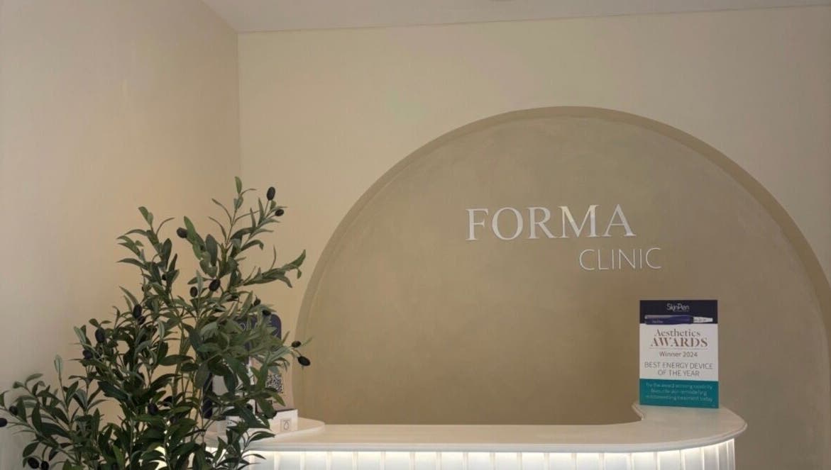 Reception area with olive plant at Relaxed by Kelly, Edinburgh, GB, showcasing a serene spa atmosphere.