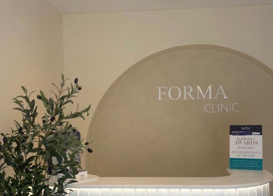 Reception area with olive plant at Relaxed by Kelly, Edinburgh, GB, showcasing a serene spa atmosphere.