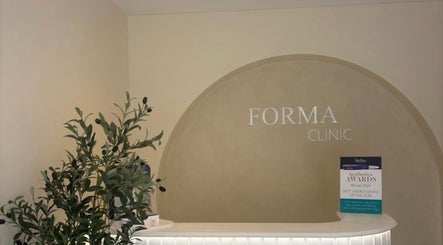 Reception area with olive plant at Relaxed by Kelly, Edinburgh, GB, showcasing a serene spa atmosphere.