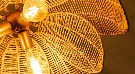 Elegant woven lamp at Hebra Beauty Studio, Guaynabo, Guaynabo, PR, casting warm light.