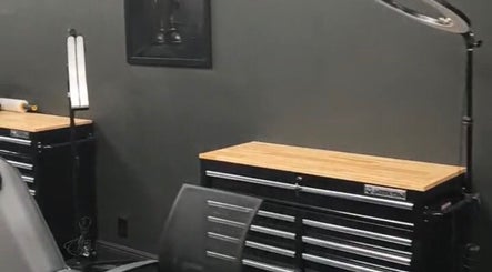 Modern workspace in Perfect Match Ink, Margate, Florida, US featuring sleek black tool cabinets.