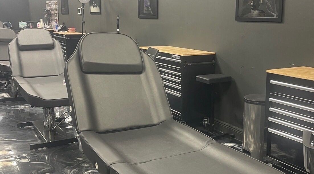 Modern tattoo studio at Perfect Match Ink in Margate, Florida, US featuring sleek black chairs.