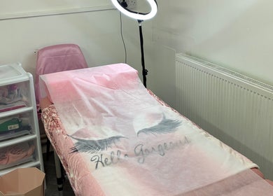 Cozy treatment room at The beauty cabin x in Sunderland, England, GB, featuring a pink massage bed and soft lighting.