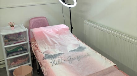 Cozy treatment room at The beauty cabin x in Sunderland, England, GB, featuring a pink massage bed and soft lighting.