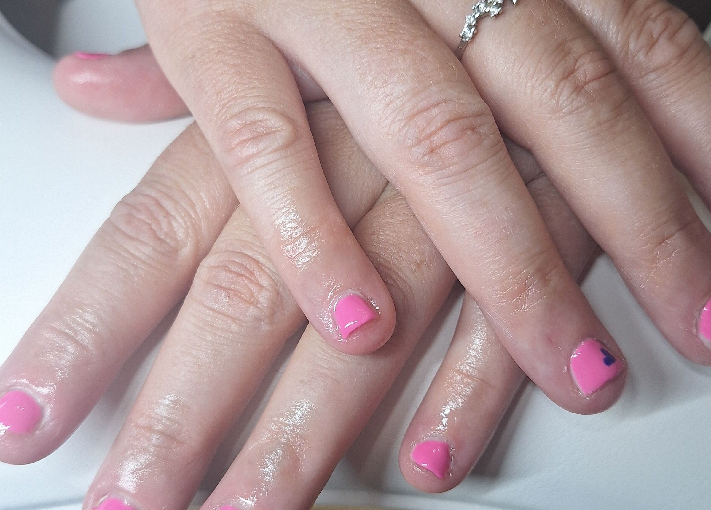 Manicured hands with pink polish at Polished and Pretty, Crynant, Wales, GB.