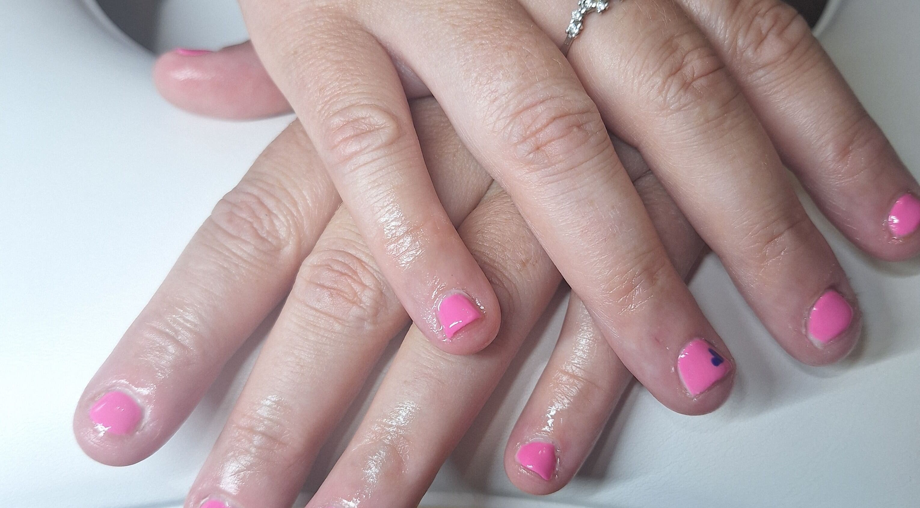 Manicured hands with pink polish at Polished and Pretty, Crynant, Wales, GB.