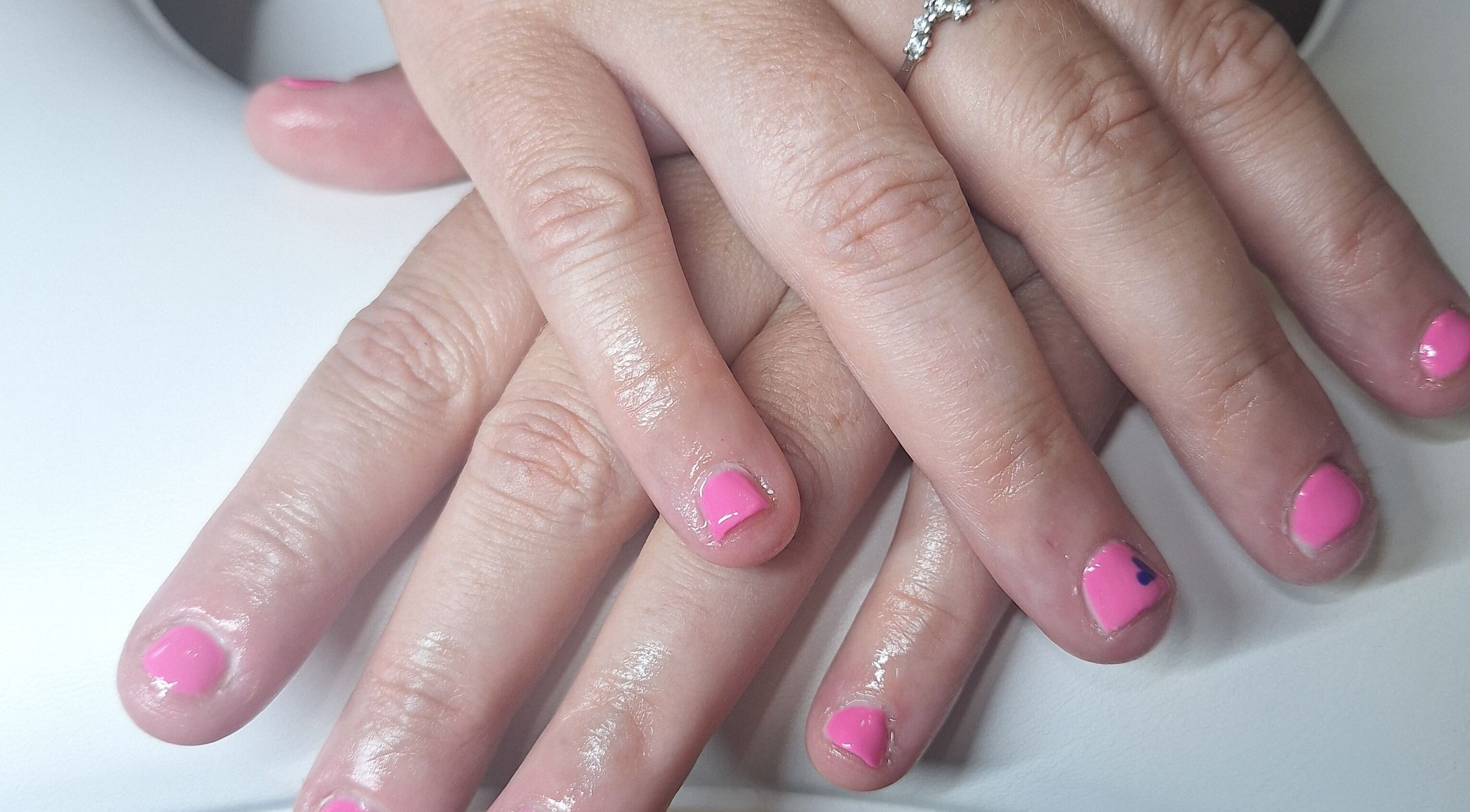 Manicured hands with pink polish at Polished and Pretty, Crynant, Wales, GB.