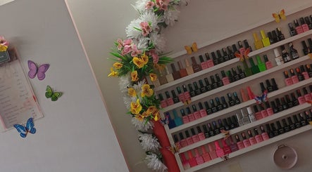 Vibrant nail polish display at Luv Ur Nails, Roseau, Saint George Parish, DM, with floral decor.
