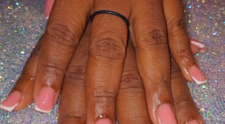 Close-up of French manicure at Luv Ur Nails in Roseau, Saint George Parish, DM, on a glittery background.