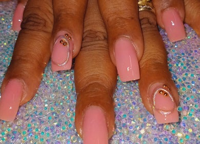 Elegant nail art at Luv Ur Nails, Roseau, Saint George Parish, DM, featuring shimmering pink and rhinestone designs.