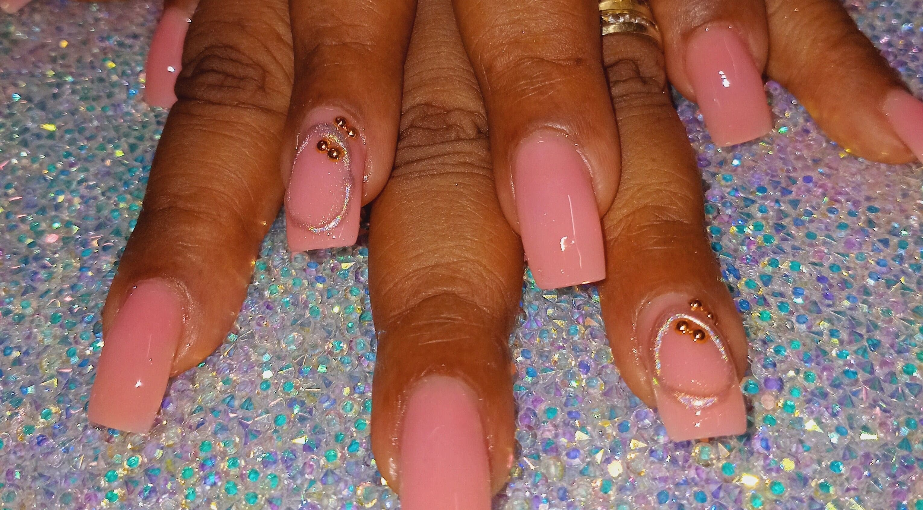Elegant pink acrylic nails at Luv Ur Nails, Roseau, Saint George Parish, DM with rhinestone accents.