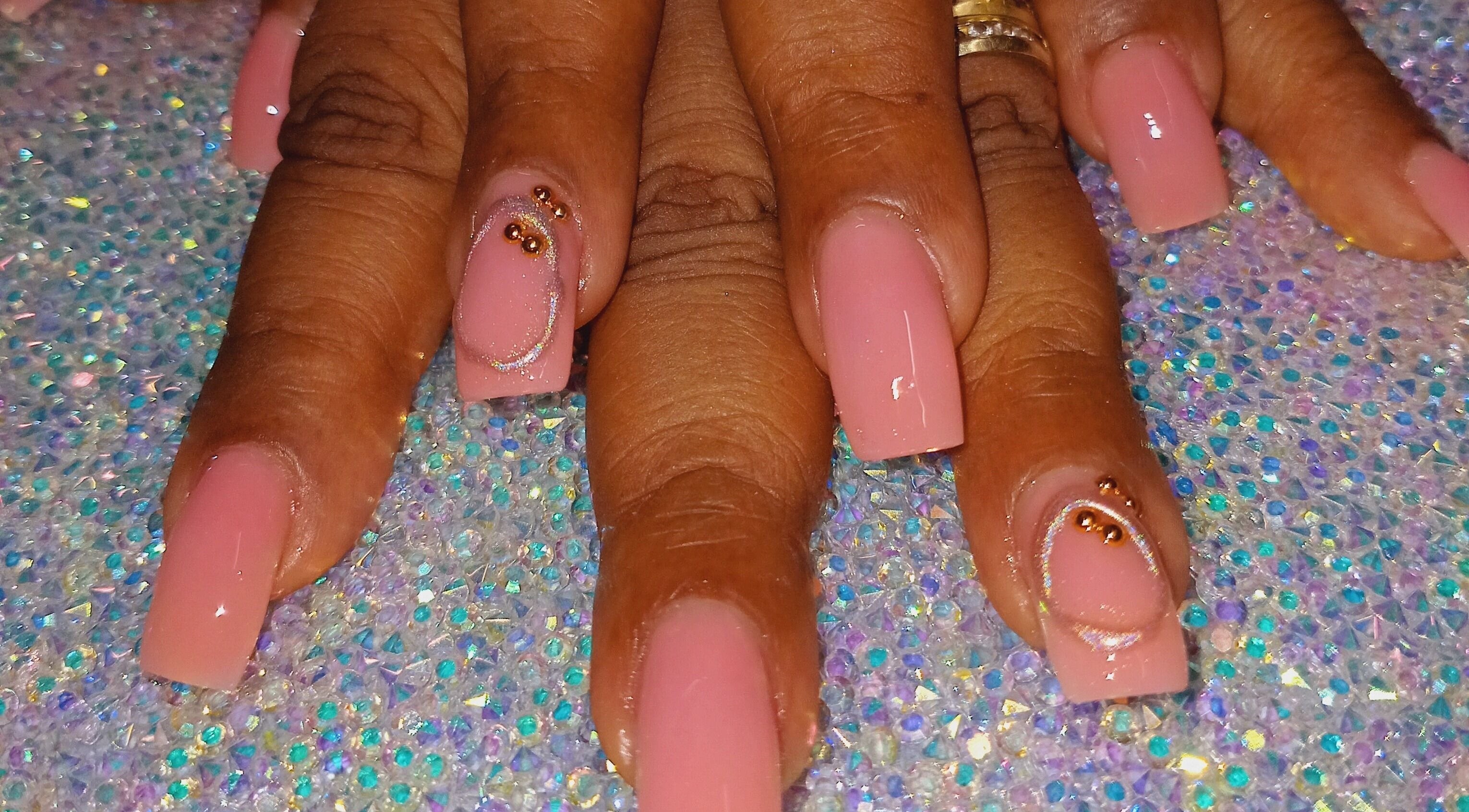 Elegant pink acrylic nails at Luv Ur Nails, Roseau, Saint George Parish, DM with rhinestone accents.