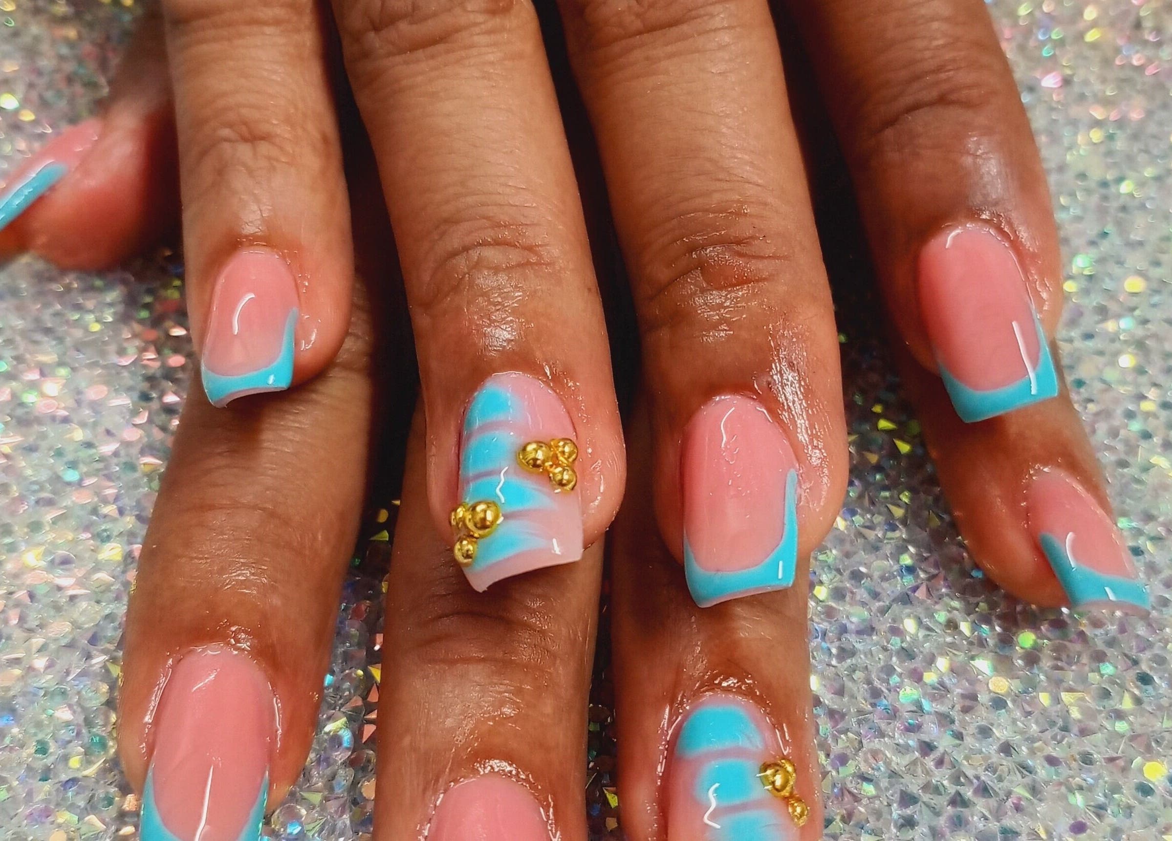 Stylish blue-tipped nails with gold accents at Luv Ur Nails, Roseau, Saint George Parish, DM.