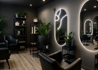 Luxurious salon interior at VixenChair, Concord, North Carolina, US, featuring chic black chairs and ambient lighting.