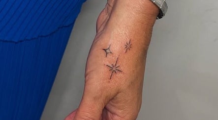 Intricate star tattoo on hand at Nail and Needle Clinic, Great Warley, England, GB.