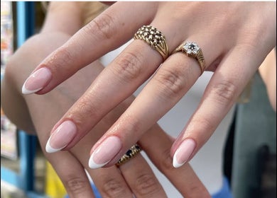 Elegant French manicure with rings at Nail and Needle Clinic in Great Warley, England, GB.