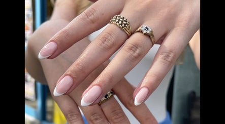 Elegant French manicure with rings at Nail and Needle Clinic in Great Warley, England, GB.