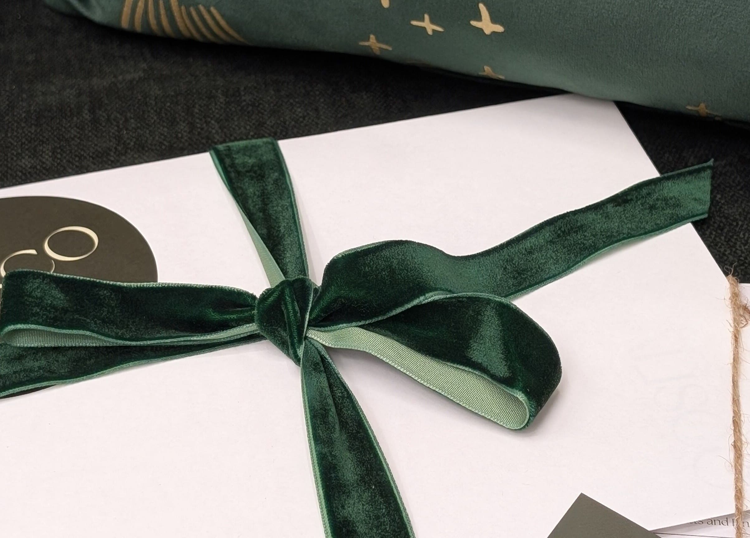 Elegant gift wrap with Alisco Nail Spa branding in Shipley, England, GB. Luxurious green ribbon detail.