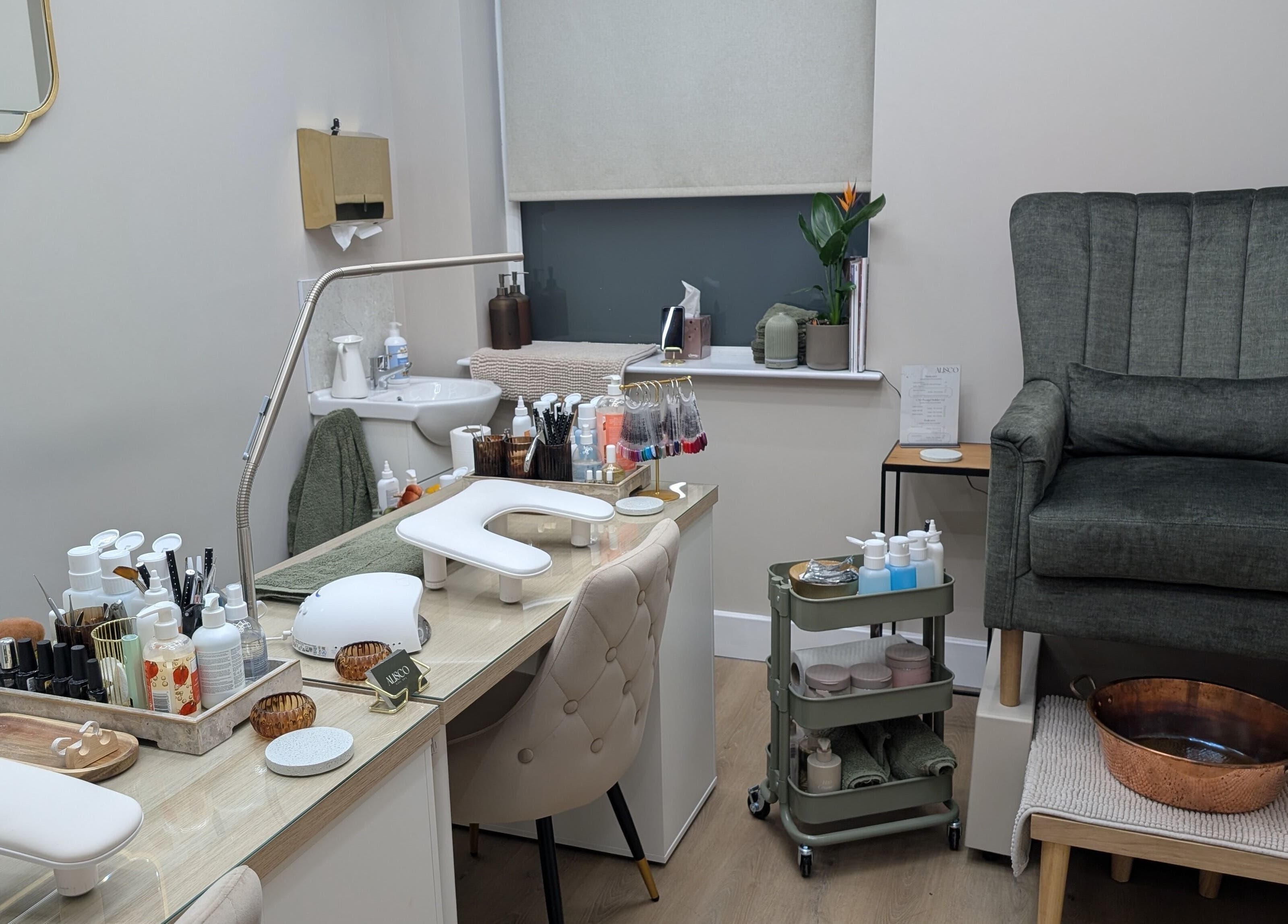 Cozy nail treatment area at Alisco Nail Spa, Shipley, England, GB, featuring elegant chairs and nail products.