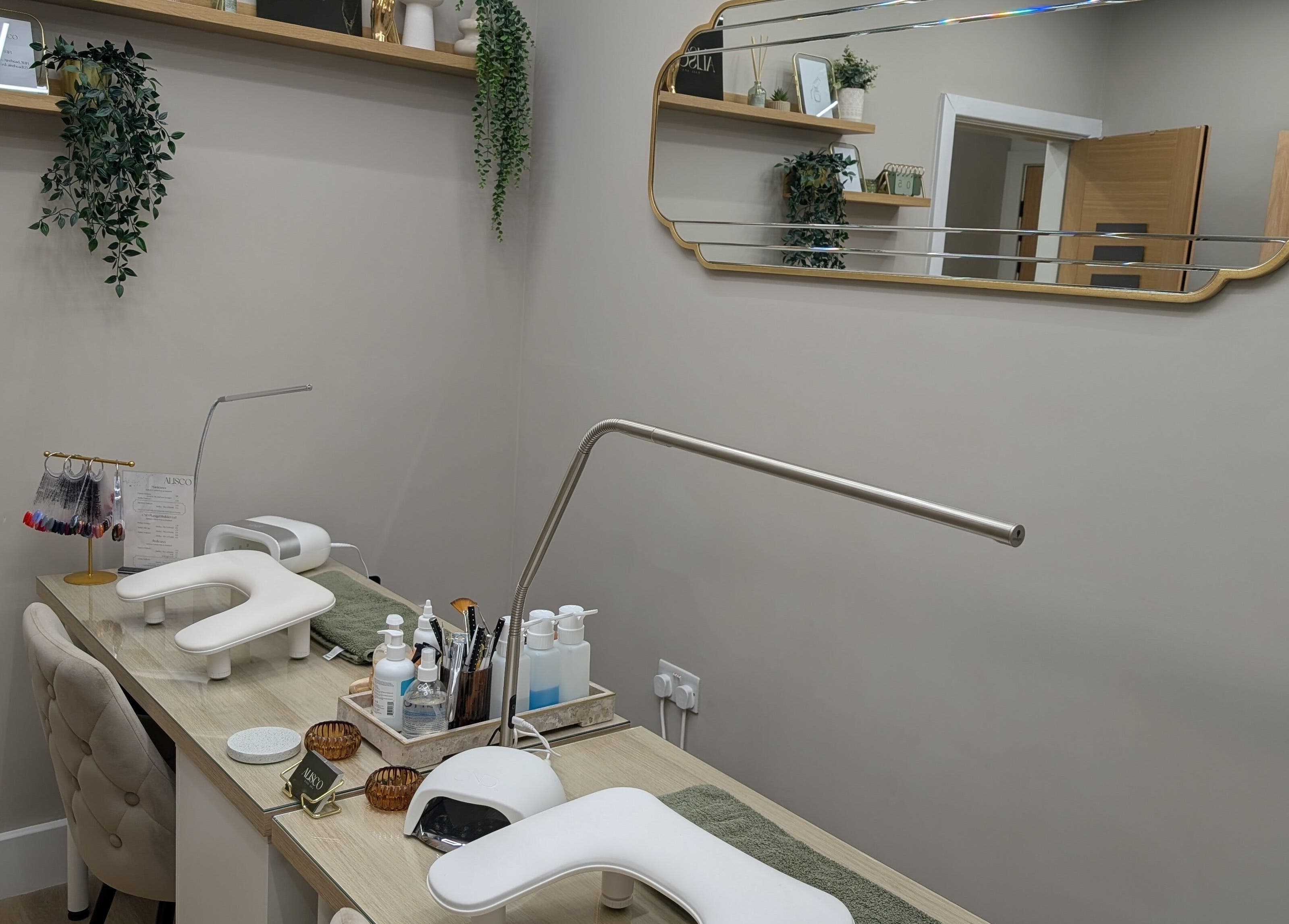 Interior of Alisco Nail Spa in Shipley, England, GB showing chic nail treatment stations.