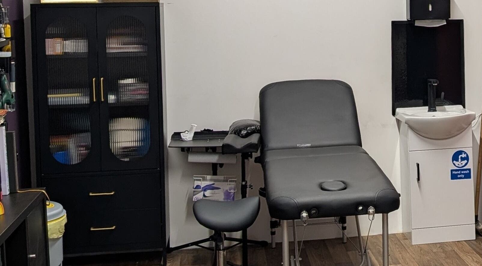 Massage room at Shadow Bloom Studio in Oldham, England, GB with treatment bed and storage cabinet.