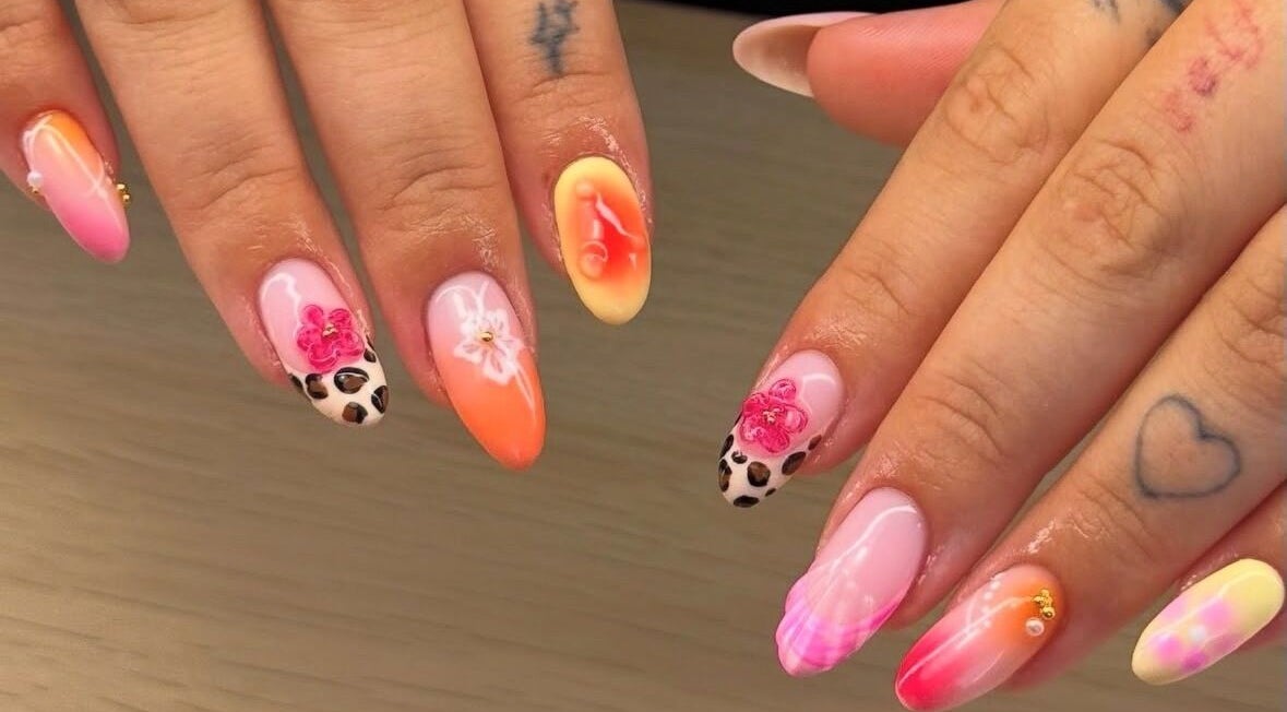 Vibrant floral and leopard nail art at BYGLT in Morriston, Wales, GB. Showcasing unique nail design.