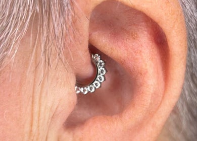 Pretty piercings at Sirens Song in Queensferry, Scotland, GB, showcasing a sparkling ear accessory.