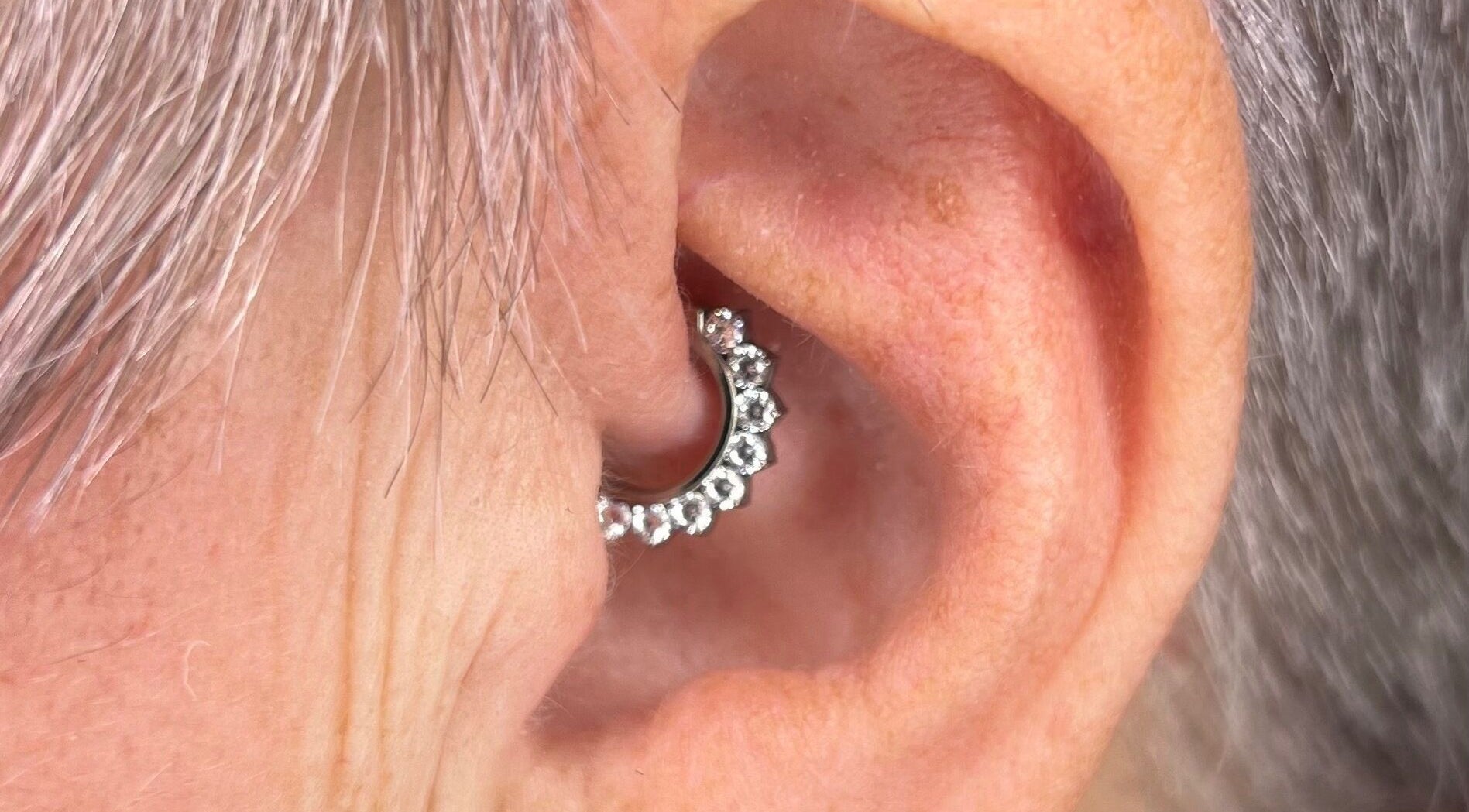 Pretty piercings at Sirens Song in Queensferry, Scotland, GB, showcasing a sparkling ear accessory.