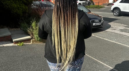 Long, stylish braids showcased at Luxury hair by honeybee, Crewe, England, GB on a sunny day.