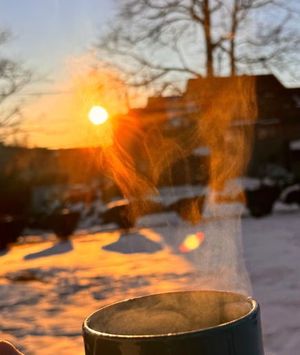 Steam rising from a mug at sunrise in Jonas Wayne, Norwalk, Connecticut, US snowy landscape.
