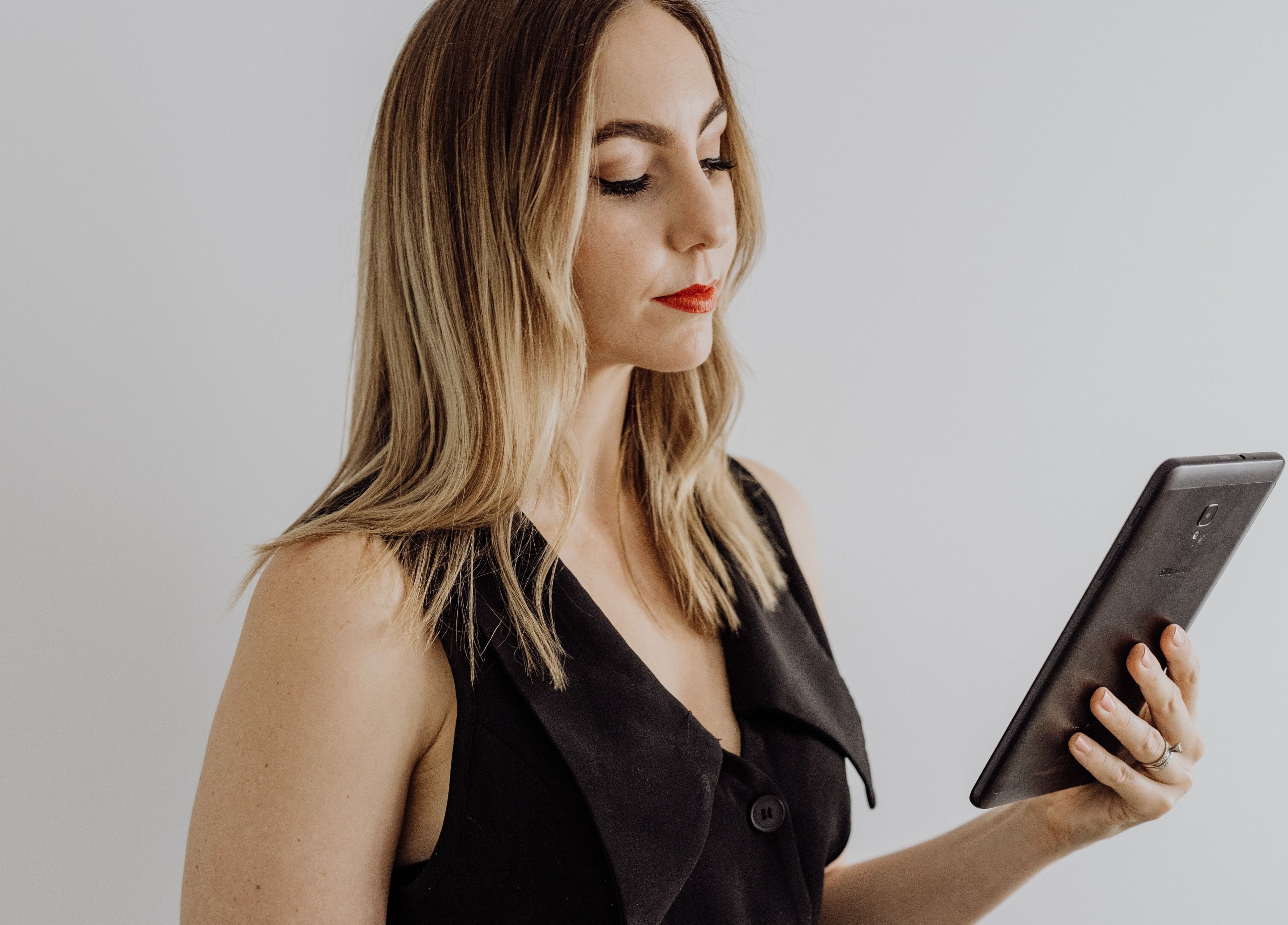 Professional using tablet at Beauty on Bertha, Logan Reserve, Queensland, AU for beauty consultation.