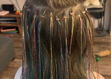 Colorful hair tinsel extensions at Heidi Hair, Edinburgh, Scotland, GB for a dazzling look.