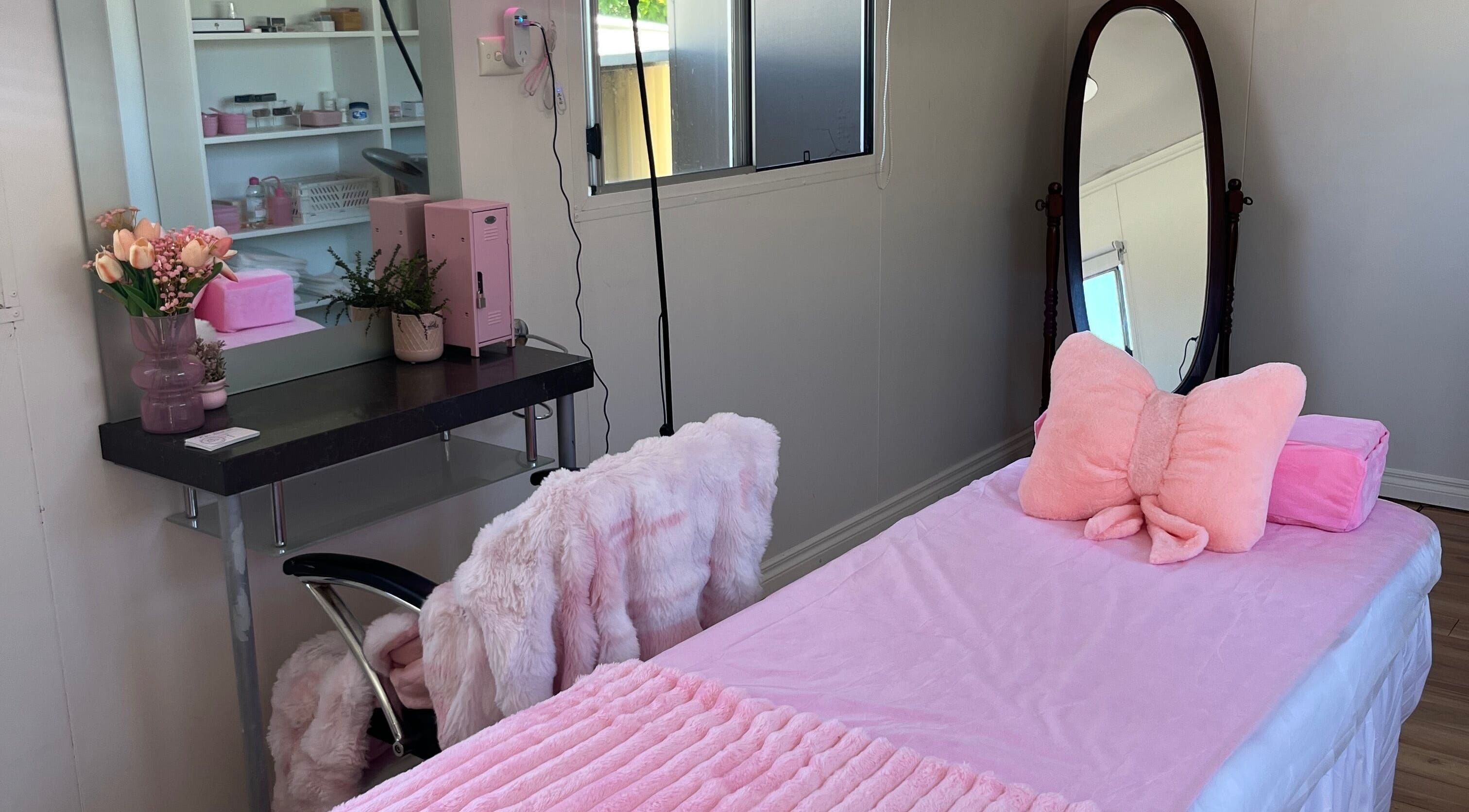 Elegant treatment room at Mya's Beauty Studio, Kardinya, Western Australia with pink decor and mirrored vanity.