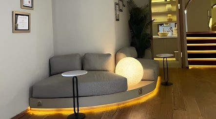 Cozy lounge at NA Clinic, Bali with ambient lighting and modern decor.