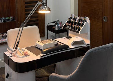 Modern nail station at Beautybyalmira, St Albans, England, GB, with manicure tools and polish selection.
