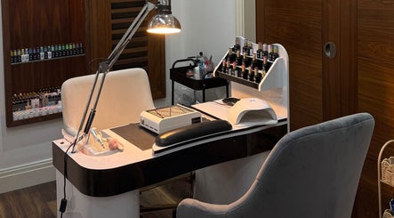 Modern nail station at Beautybyalmira, St Albans, England, GB, with manicure tools and polish selection.
