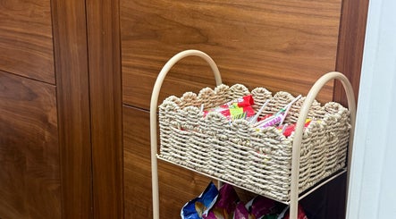 Wicker basket with snacks at Beautybyalmira, St Albans, England, GB enhances guest experience.