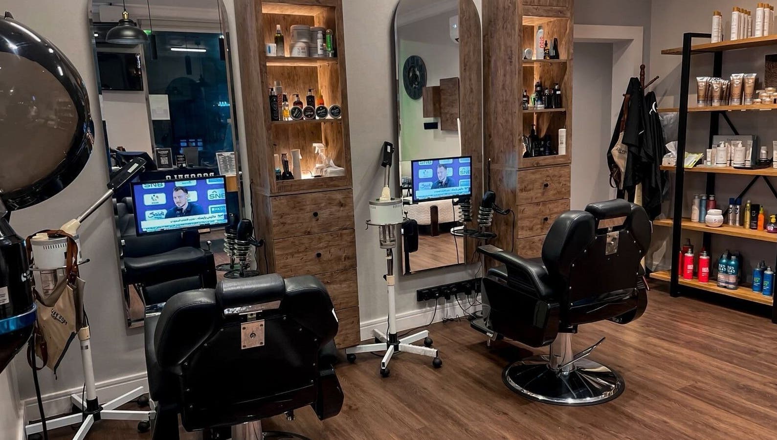 Modern interior of Poco Pelo Barbershop in Al Khobar, Eastern Province, SA featuring stylish barber chairs and products.