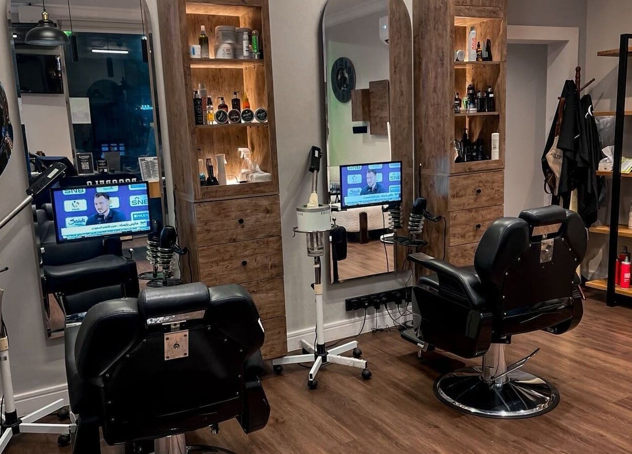 Modern interior of Poco Pelo Barbershop in Al Khobar, Eastern Province, SA featuring stylish barber chairs and products.